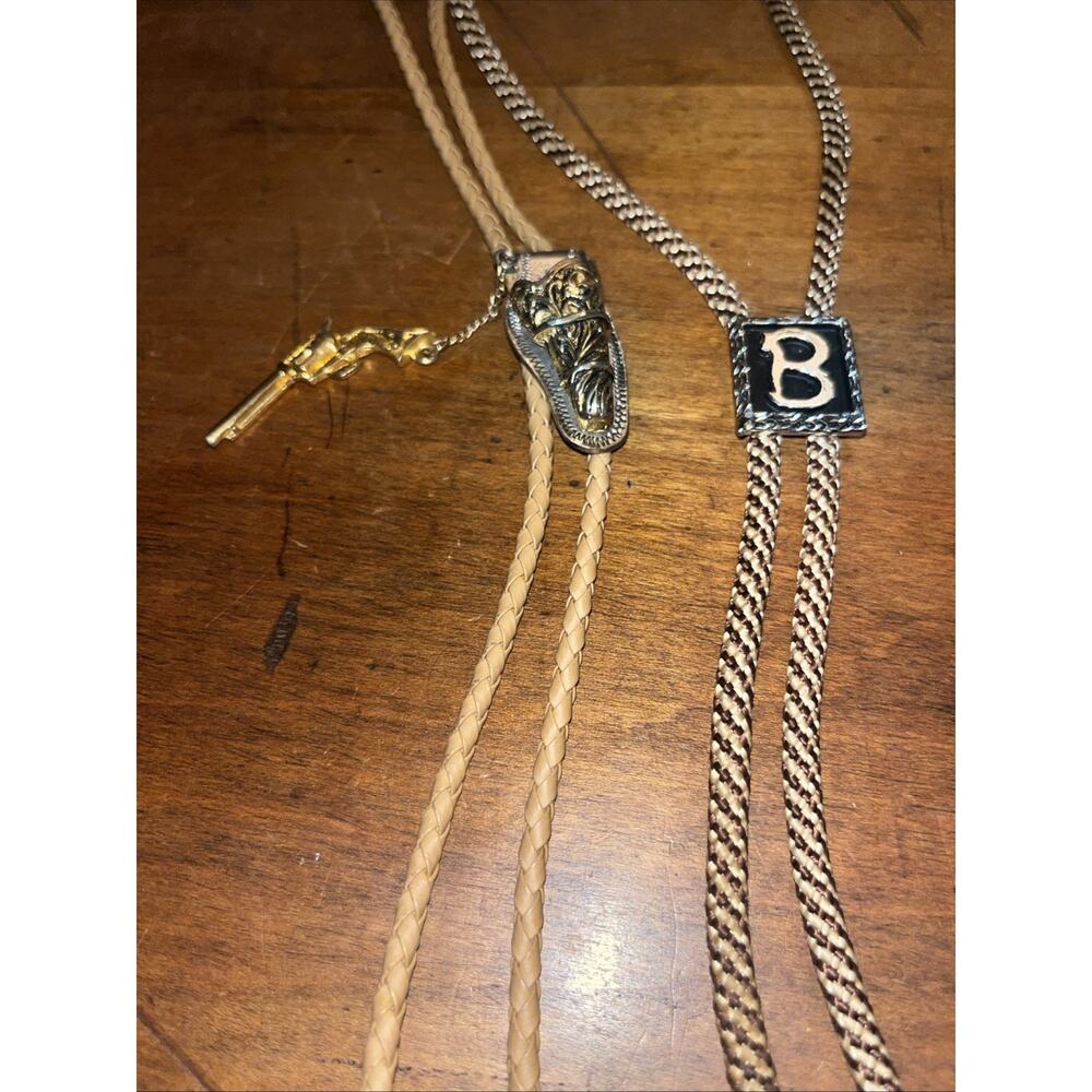 Set Of 2 Bolo Ties One With A Removable Gun And Holster And One With A B